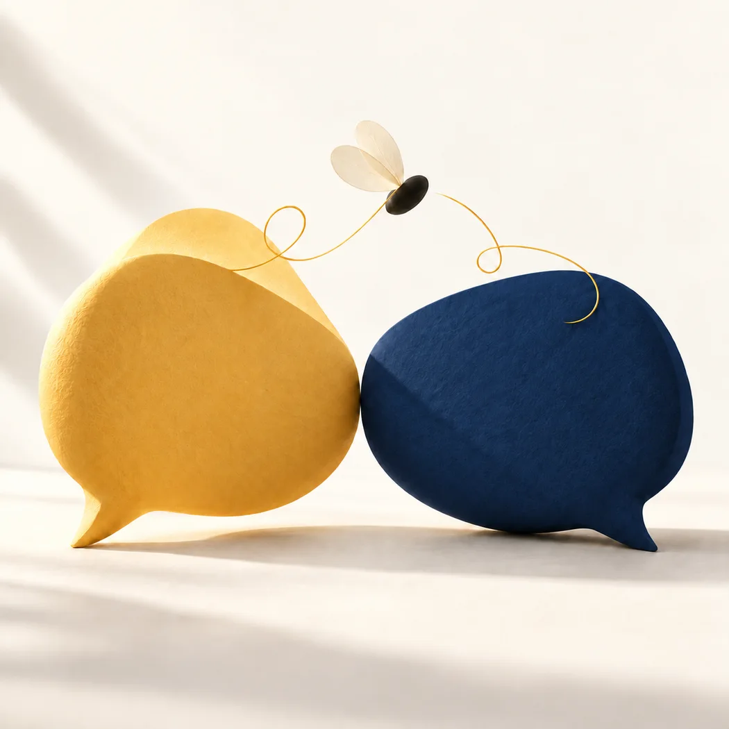 Honey-gold and navy speech bubbles, connected by the gentle flight of a small bee